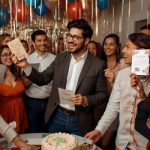 a man celebrating his birthday amongst friends at a party, he is enjoying his cards by nettie creates