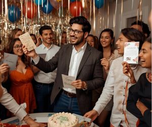 a man celebrating his birthday amongst friends at a party, he is enjoying his cards by nettie creates